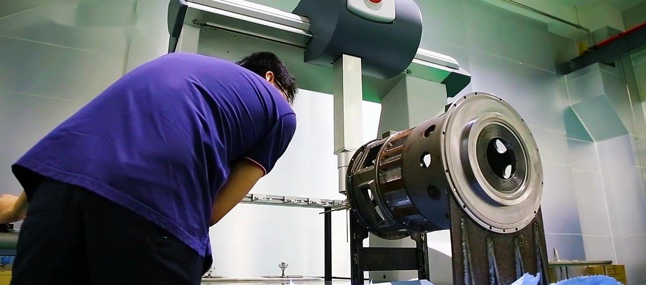 Technician checking a permanent magnet motor rotor