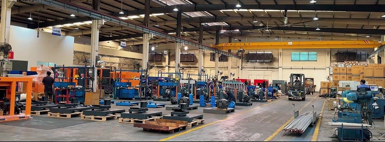 Assembly workshop floor with overhead crane and compressor frames
